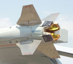 the tail end of an airplane that is flying in the sky