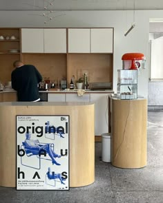 a man standing at the counter in a kitchen