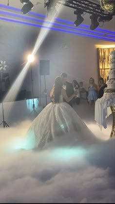 a bride and groom are kissing in the clouds at their wedding reception, surrounded by lights