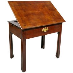 an old wooden desk with one drawer on the top and two legs at the bottom