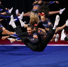 a group of cheerleaders doing tricks in the air