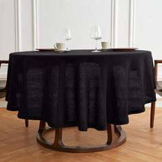 the table is set with two glasses on it, and there are no people around