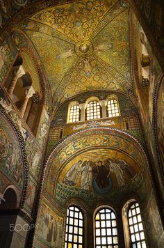 the interior of an ornately decorated building with many windows and paintings on the walls