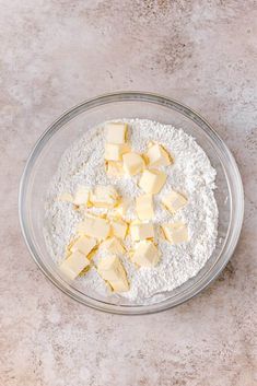 a bowl filled with flour and butter on top of a table