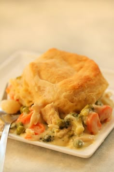 a chicken pot pie on a plate with a fork