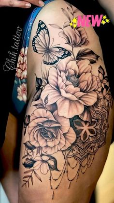 a woman's thigh with flowers and butterflies on it