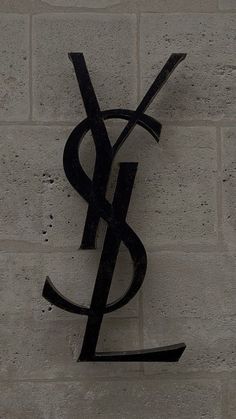 a sign on the side of a building that says y & s and is black