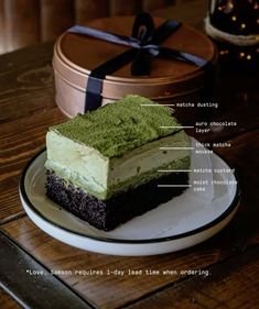 a piece of cake sitting on top of a white plate next to a brown box