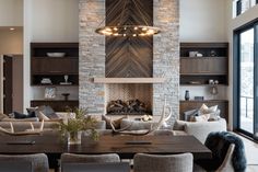 a living room filled with furniture and a fire place in the middle of a room