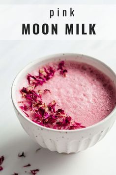 pink moon milk in a white bowl with rose petals on the rim and text overlay that reads, pink moon milk