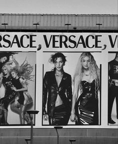 black and white photograph of three billboards with women in leather outfits on the side