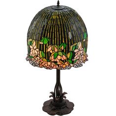 a lamp that is sitting on top of a wooden base and has flowers painted on it