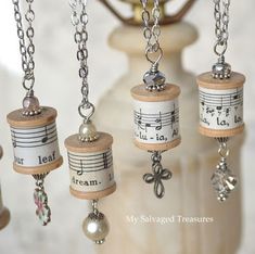 musical notes and bells are hanging from a vase with beads on it's sides