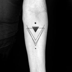 a black and white photo of a man's arm with a geometric tattoo on it