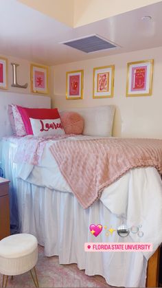 a bedroom with pink and white decor on the walls