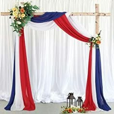 an arch decorated with red, white and blue draping for a wedding ceremony