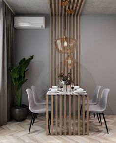 a dining room table with chairs and a vase on top of it next to a plant