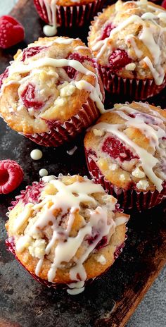 raspberry muffins with icing on a cutting board