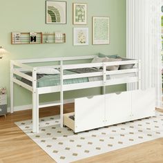 a white bunk bed sitting on top of a hard wood floor