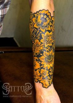 a person with a yellow and black tattoo on their leg