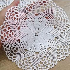 a white doily on a wooden table