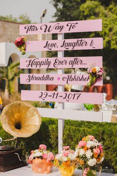 a sign that says this way to love, laughter and happily ever after