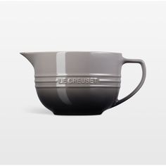 a gray and white ceramic pitcher with the word true crumbet on it's side