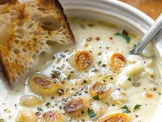 a close up of a bowl of soup with bread