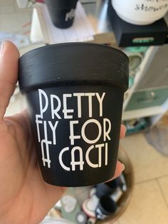 a person holding up a cup with the words pretty fly for caci on it