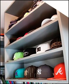 hats are lined up on shelves in a closet