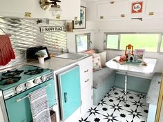 a kitchen with an oven, sink and stove top in the middle of a room