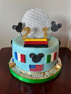 a mickey mouse cake on a wooden table