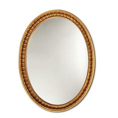 a round mirror with an intricate gold frame