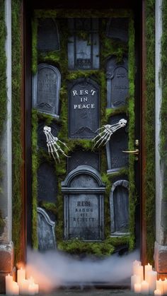 a halloween door decorated with moss and tombstones, candles and fake heads on it