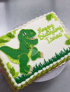 a birthday cake with a dinosaur on it