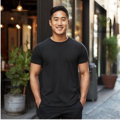 Featuring a strong Asian man wearing a black 3001 Bella Canvas T-shirt ! This mockup template is perfect for anyone in the Print-On-Demand (POD) industry or looking for a simple and stylish lifestyle mockup. With this digital download, you'll have access to high-quality images that'll be sure to make your shop stand out! Don't wait, add these beautiful mockups to your collection today! Available colors: Black Mockup Details: Brand: Bella Canvas Shirt: 3001 Classic Fit Sport Heavy Blend T-Shirt ATTN: Although most colors should match the mockups on Printify and Printful, there may be a few that are slightly off. If you encounter any issues with the color you want to use, please send me a message and I will work with you to find a solution. Size: Large Digital Download: This is an instant do Confident Man, Shop Stand, Stylish Lifestyle, Urban City, City Streets, Black T Shirt, Color Photography, Quality Images, Male Model