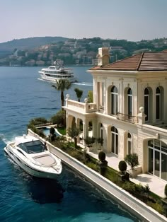 a boat is in the water next to a large house