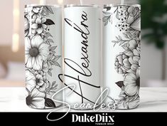 three white cans with black and white flowers on them, one has the word beautiful written in cursive writing