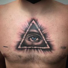 a man's chest with an all seeing eye tattoo on it