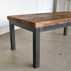 a wooden table sitting on top of a cement floor