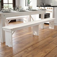 a white table and bench in a kitchen