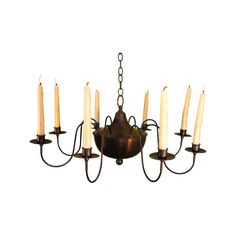 a chandelier with six lit candles hanging from it's center and four arms