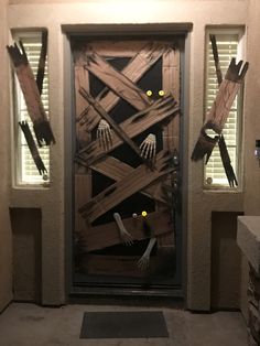 a door decorated with skeleton hands and yellow eyes