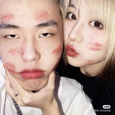 two people with makeup on their faces posing for the camera