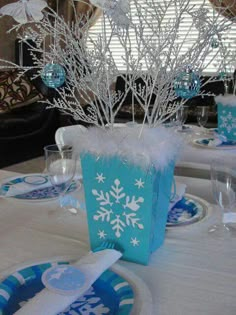 the table is set with blue and white decorations