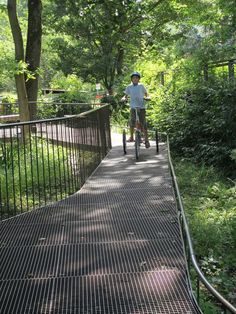 a person riding a bike on a path in the woods