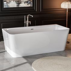 a white bath tub sitting on top of a tiled floor next to a rug and lamp