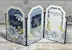 three handmade cards with flowers on them, one is blue and the other is white