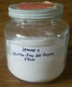 a jar filled with flour sitting on top of a wooden table