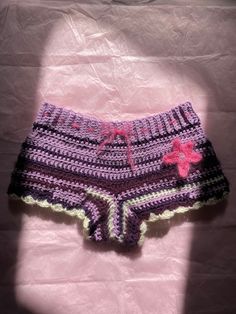 the shorts are crocheted and have pink flowers on them